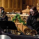 Gallery 4 - Handbell ringer playing large bass bells. 