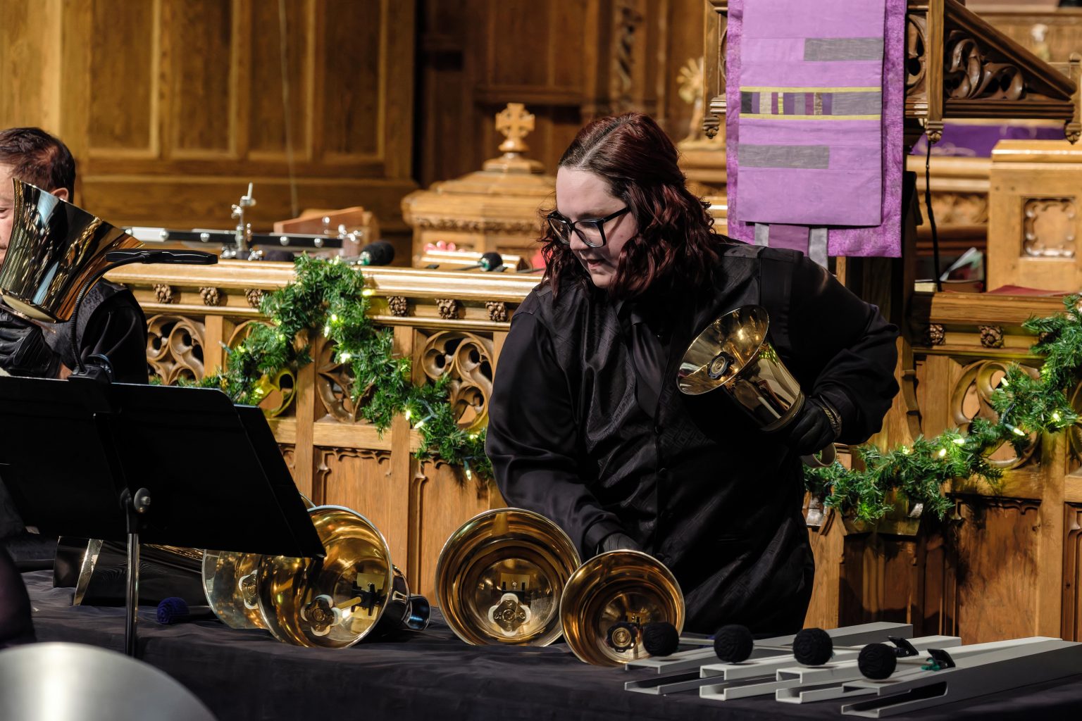 Gallery 4 - Handbell ringer playing large bass bells. 