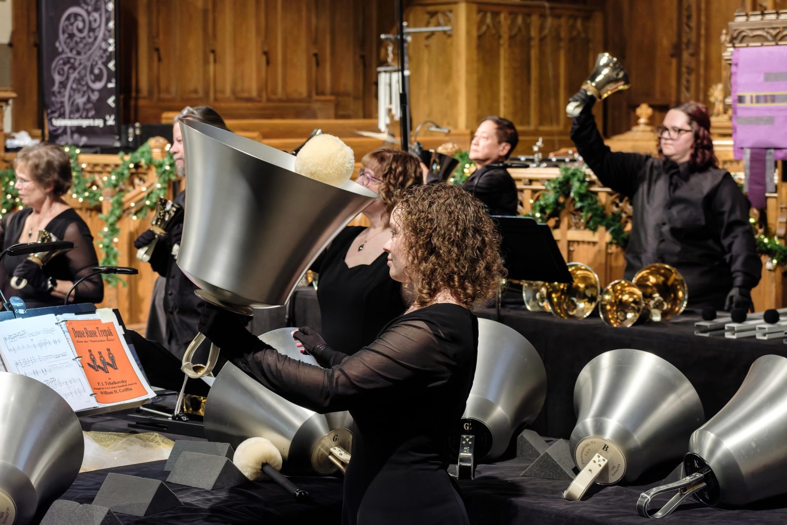 Gallery 1 - Handbell ringers plays a large aluminum bass bell