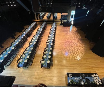 Rows of tables decorated for a wedding meal
