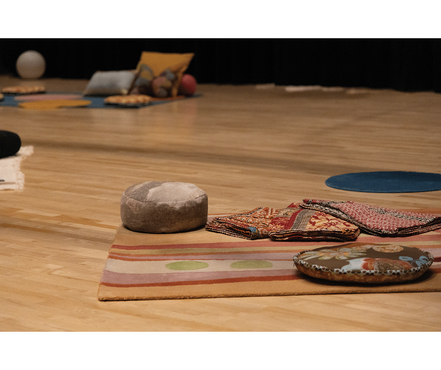 Gallery 2 - Theatre with blankets and pillows placed around the wood floor